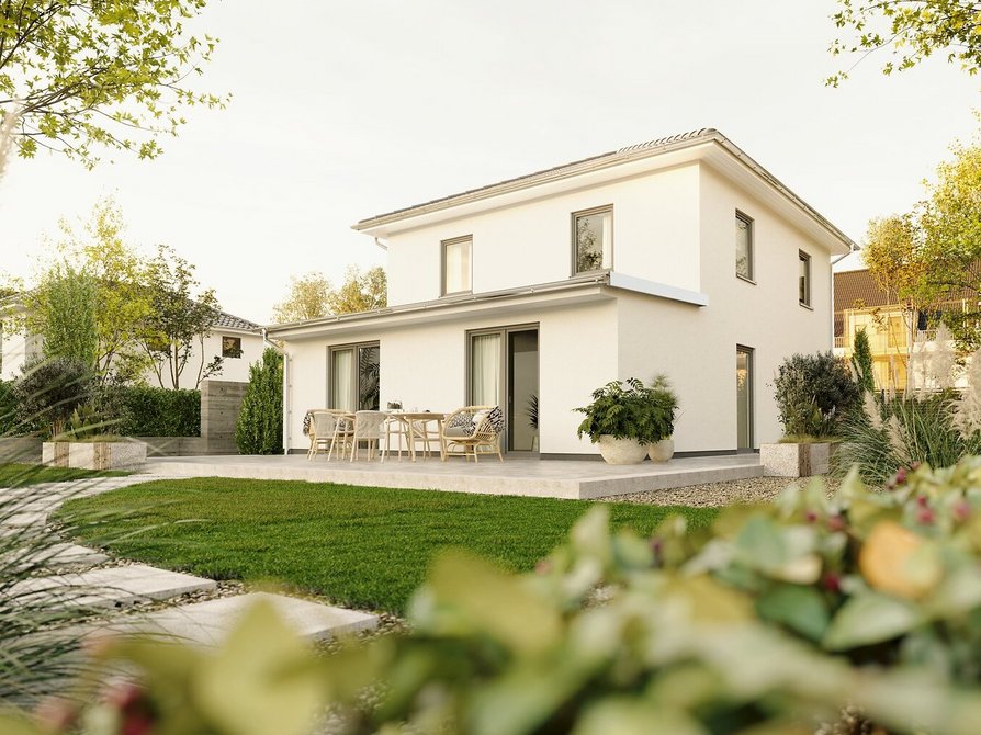 Stadthaus Flair 124 mit Staffelgeschoss – Gartenansicht mit Terrasse Moderne Rückansicht des Stadthauses Flair 124 mit Staffelgeschoss, großzügiger Terrasse und gepflegtem Garten im Abendlicht